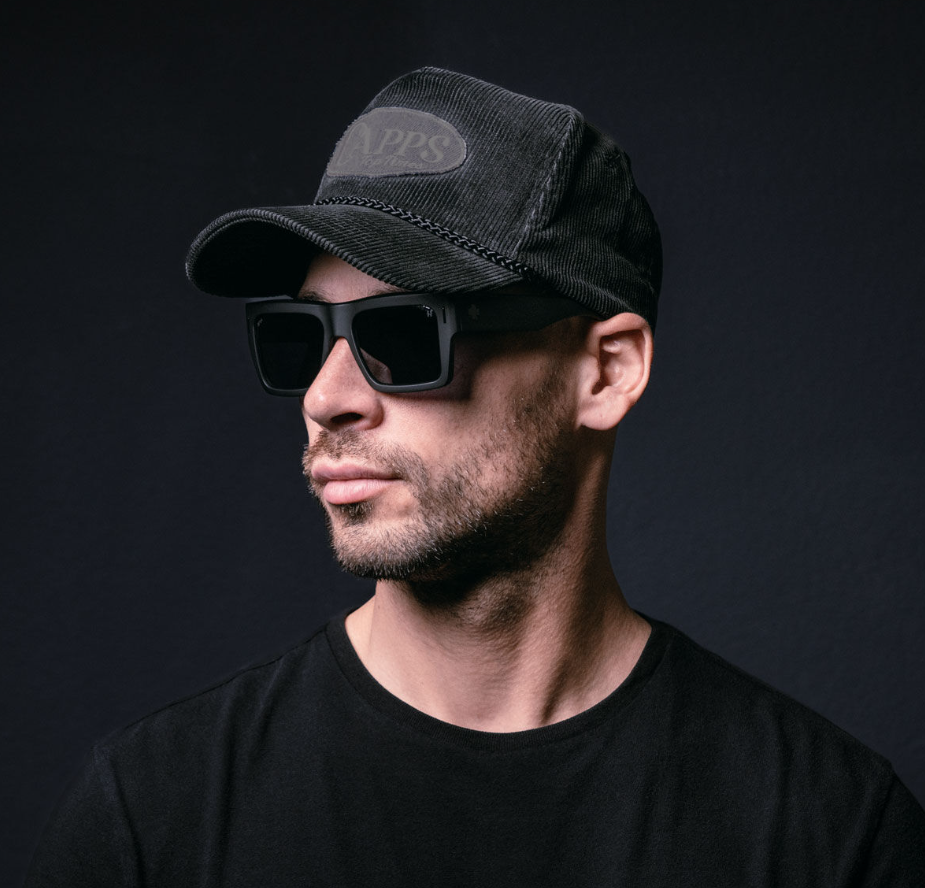 Spy Bowery Matte Black frames with Happy Polarised Murdered Lens Sunglasses on model in black cord cap