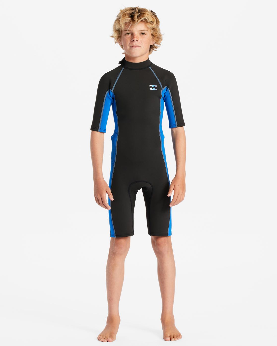 Blond kid wearing the Billabong Boys Absolute 2mm Spring Wetsuit in blue fade
