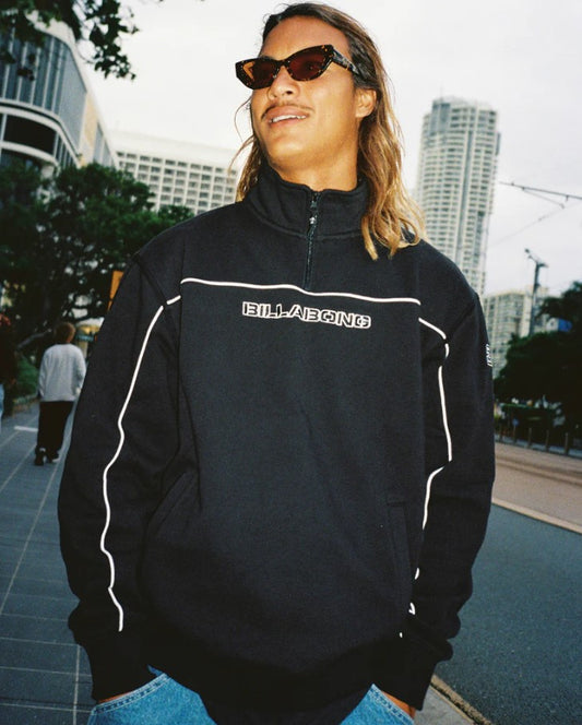 Billabong Bracket 1/4 Zip Crew in black on model in the city