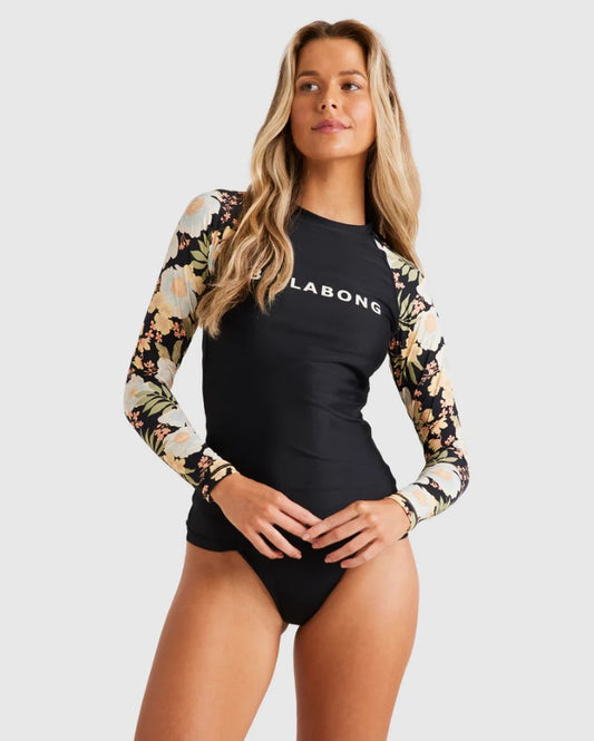 Billabong Lost Cove Leilani Long Sleeve Rash Top in black pebble with floral arms from front on model