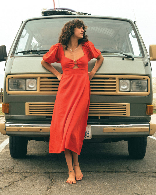 Billabong Lovers Lane Dress in rad red on model in front of green van
