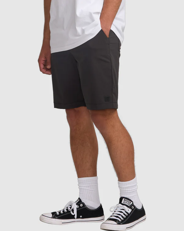 Billabong Surftrek Journey Hybrid Shorts in black on model in white tee from side
