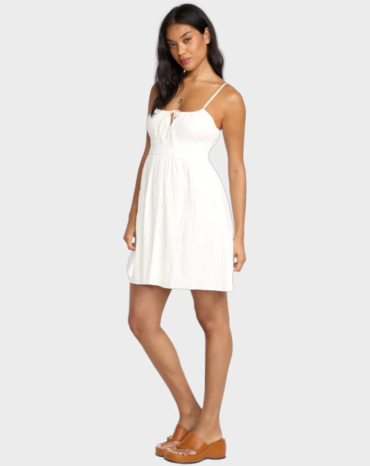 Billabong Sweet On You Mini Dress in salt crystal white on dark-haired model from side view