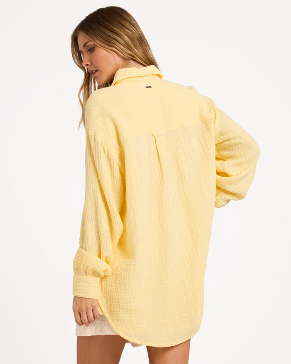 Billabong Wanderer Long Sleeve Shirt in sunlight on model in whtie shorts from  rear
