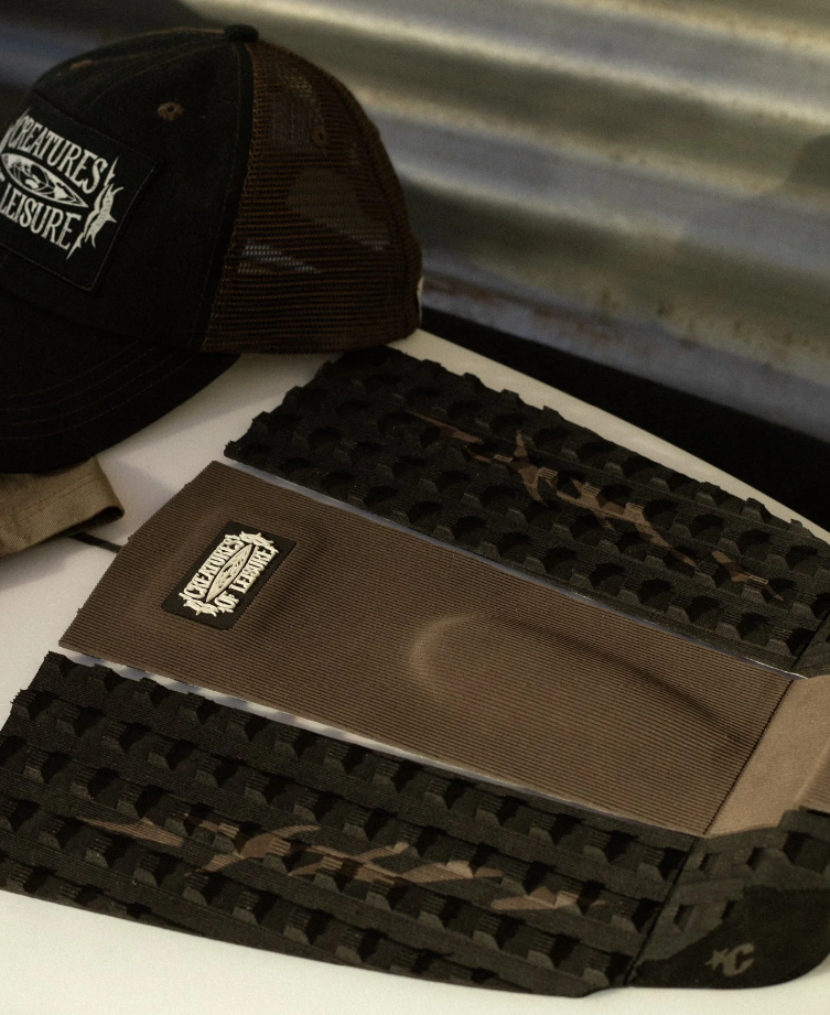 Creatures of Leisure Punish 3 Surfboard Grip in coffee and black colourway on surfboard with a creatures of leisure cap in the photo