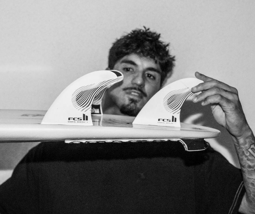 FCS II Gabriel Medina PC Tri Fin Set  in board being held by Gabriel Medina
