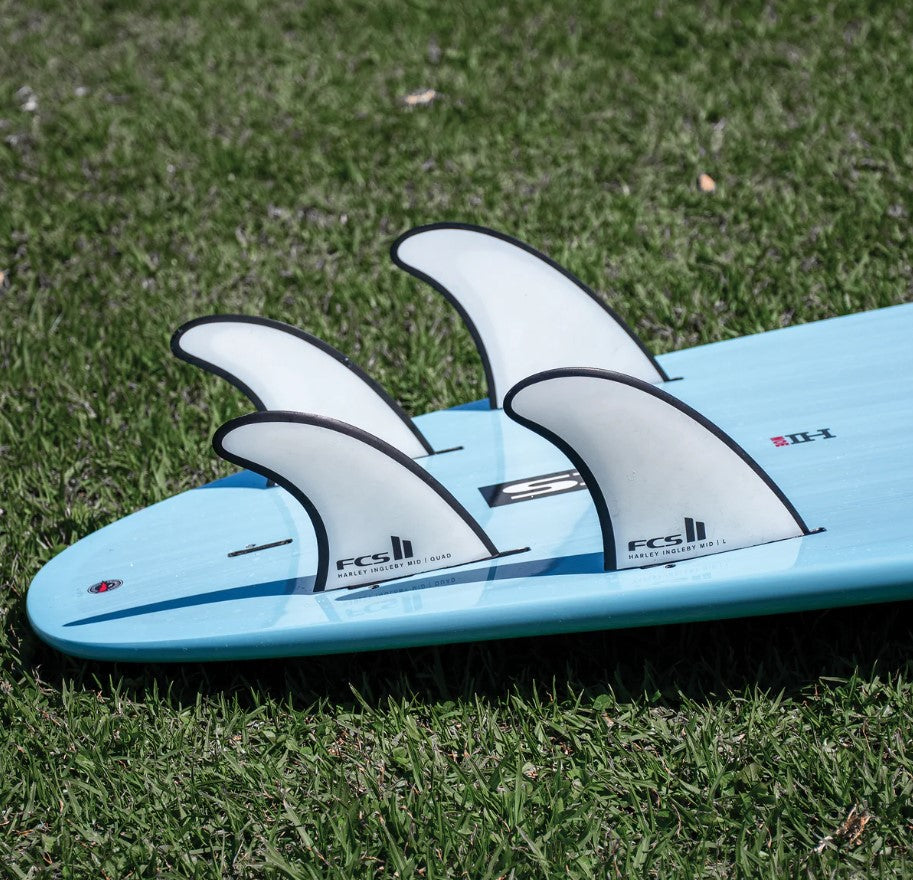 FCS II Harley Mid Tri-Quad PC Surfboard Fin Set showing 4 of the fins in a surfboard