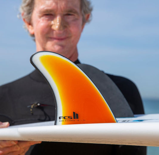 FCS II MR '78 PG Twin Fin Set in dark sunset colourway in surfboard being held by Mark Richards