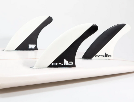 FCS II MF Mick Fanning Grom Tri Surfboard Fins in black in white shown in tail of surfboard