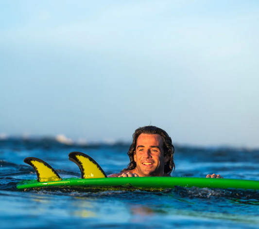 FCS II MH Mason Ho PC Aircore Surfboard Fins in yellow and black in Mason's green surfboard