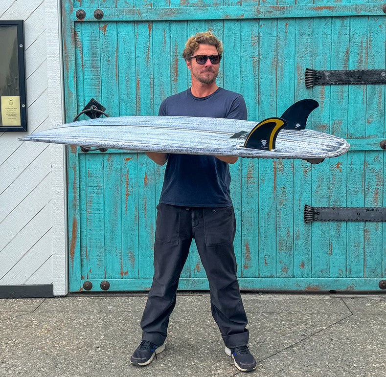 Firewire Tomo Revo Max Twin Keel Surfboard Fins in a Revo Max surfboard held by Daniel Tomo Thomson