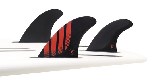 Futures Fins Pivot Alpha Carbon Thruster Fins large black and red in the tail of a surfboard