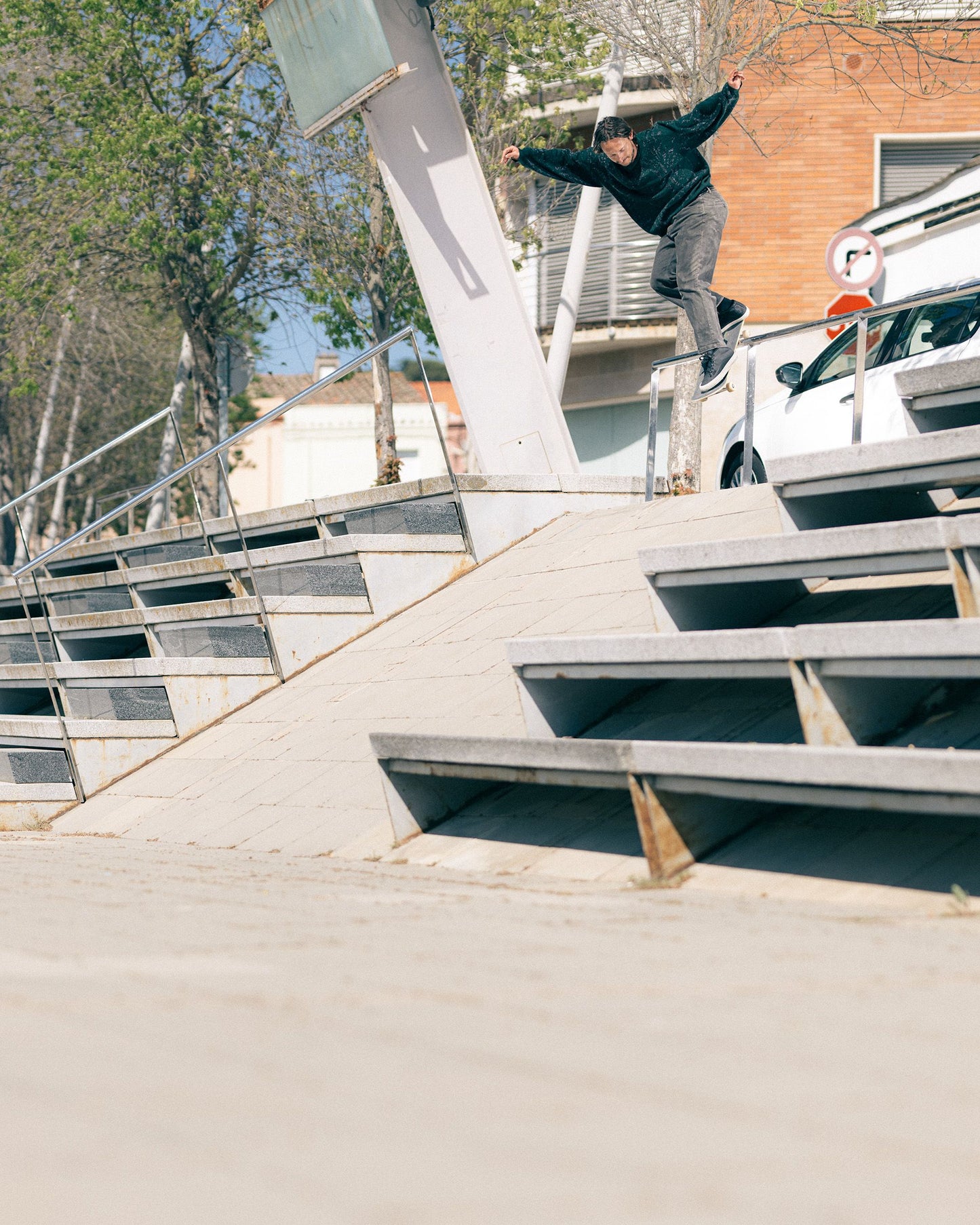 Guy doing a rail slide on his skateboard wearing the Globe Gillette Mid Shoes