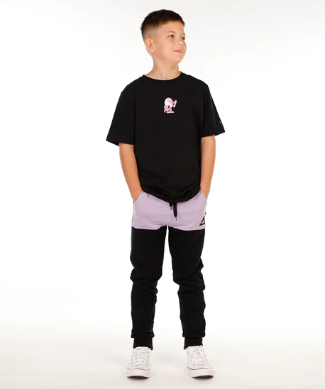 Hello Stranger Boys Pocket Track Pants in black with lavendar pocket from front on model in black Hello Stranger tee