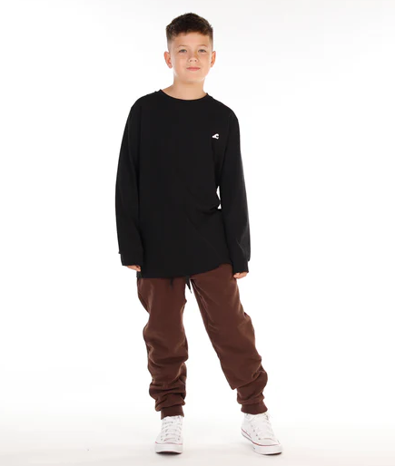 Hello Stranger Happy Boys Long Sleeve Tee in black on model from front on model in brown pants