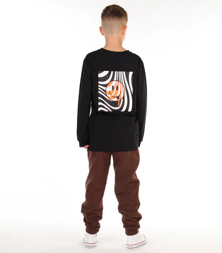 Hello Stranger Happy Boys Long Sleeve Tee in black with happy face from rear on model in brown trousers