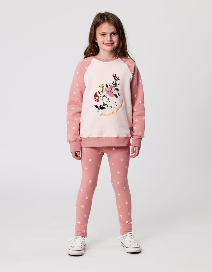Kissed By Radicool Flora Raglan Crew in pink with a floral chest print from front on model