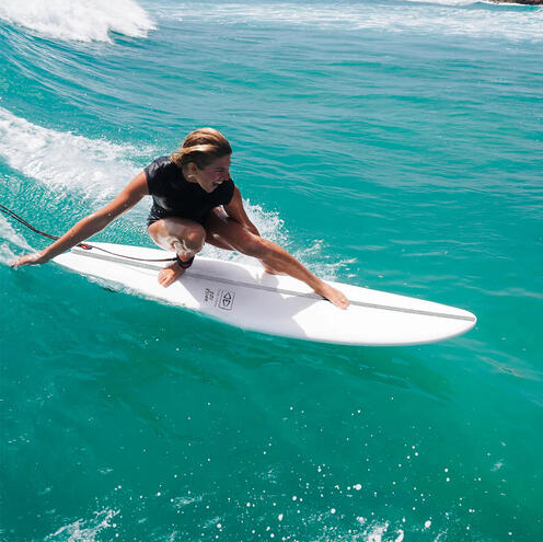 Ocean and Earth 7'0 Ezi-Rider 2.0 Softboard in white being surfed by a woman