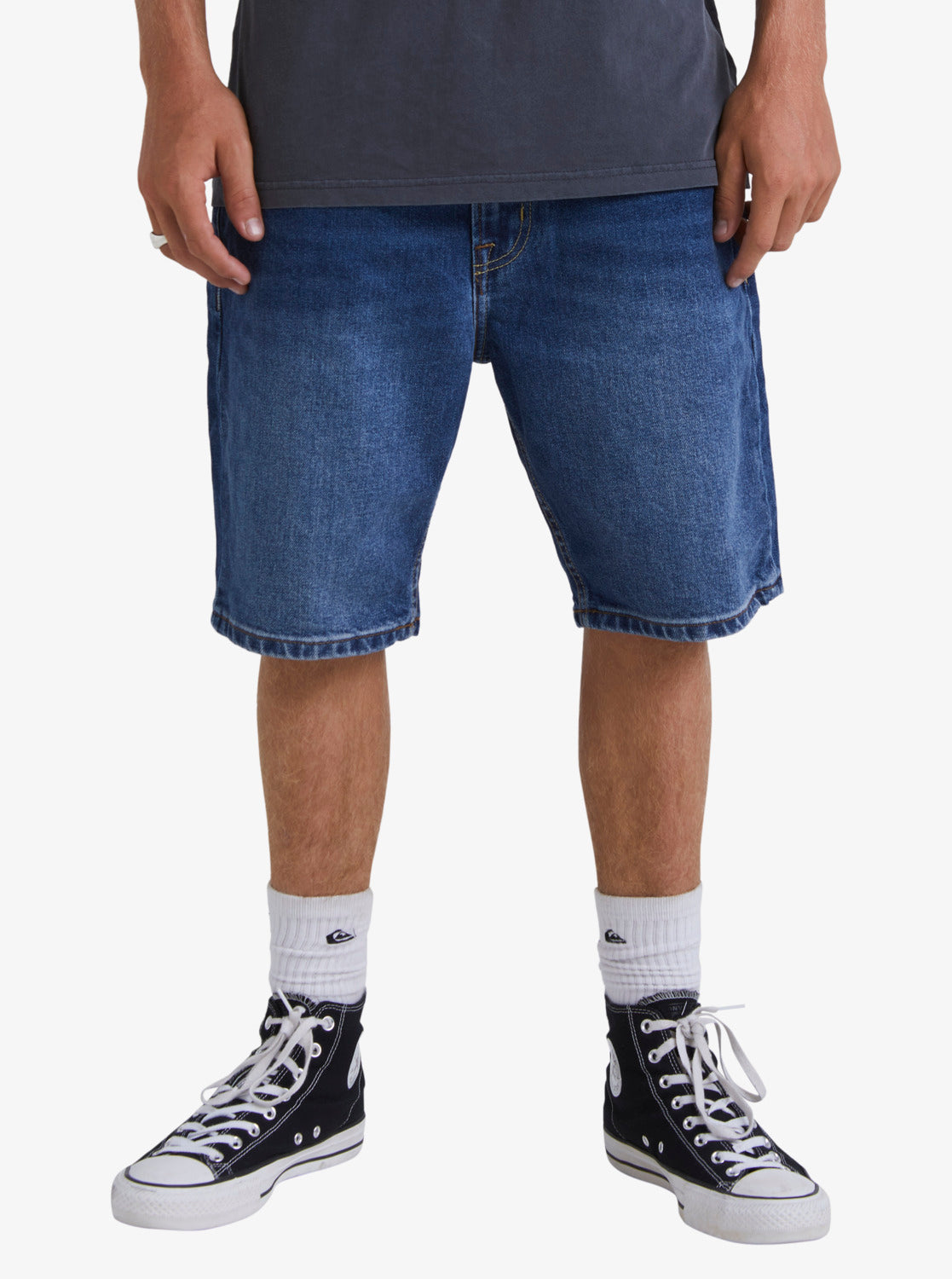 Lower part of man wearing the Quiksilver Aqua Cult 20" Aged Denim Shorts in blue
