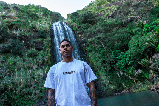 Quiksilver Kowhaiwhai-Mangopare Logo Tee in white on Kehu Butler in front of waterfall
