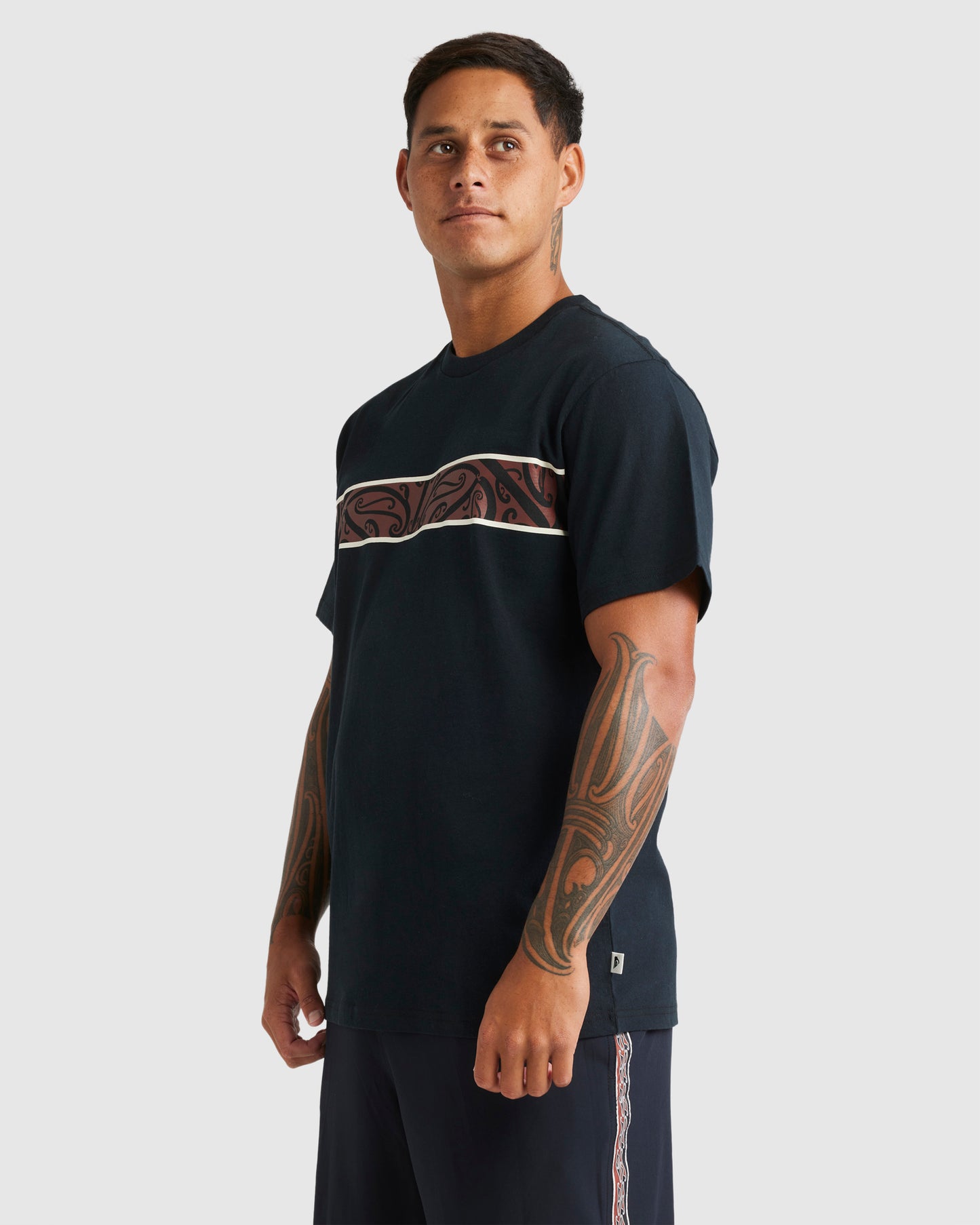 Quiksilver Kowhaiwhai-Mangopare Panel Tee in black from side on Kehu Butler