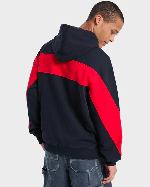 Quiksilver Mercury Trident Hoodie in black wirth red detailing on model in blue Quiksilver shorts close up from rear