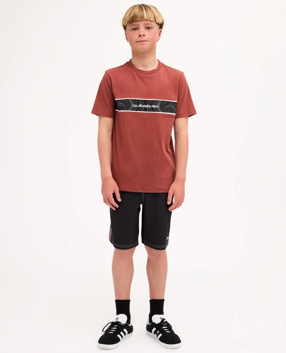 Quiksilver Tai Kehu Takarangi Panel Boys T-Shirt in henna colourway on youth model in Maori boardshorts from the front