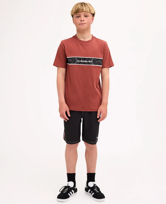 Quiksilver Tai Kehu Takarangi Panel Boys T-Shirt in henna colourway on youth model in Maori boardshorts from the front
