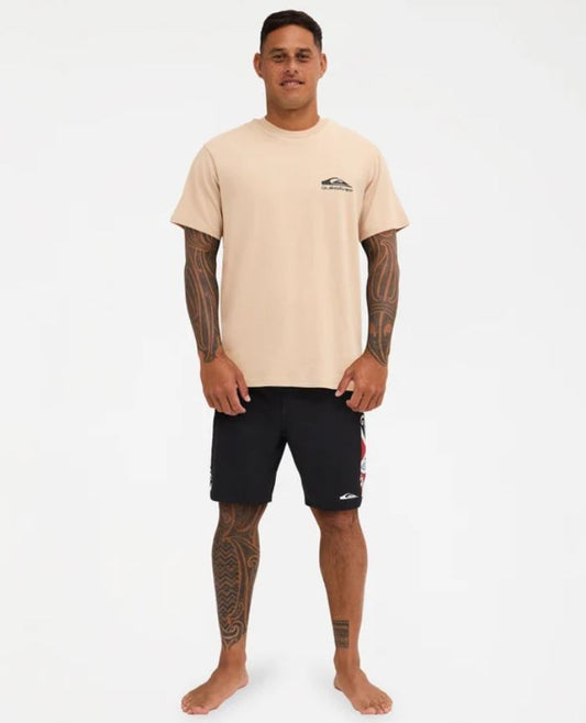 Quiksilver Tai Kehu Manu T-Shirt in light khaki on Kehu Butler in black Maori boardshorts from the front