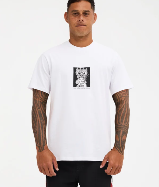 Quiksilver Tai Kehu Marakihau Men's Maori T-Shirt in white on Kehu Butler in Quiksilver Maori boardshorts from the front close up