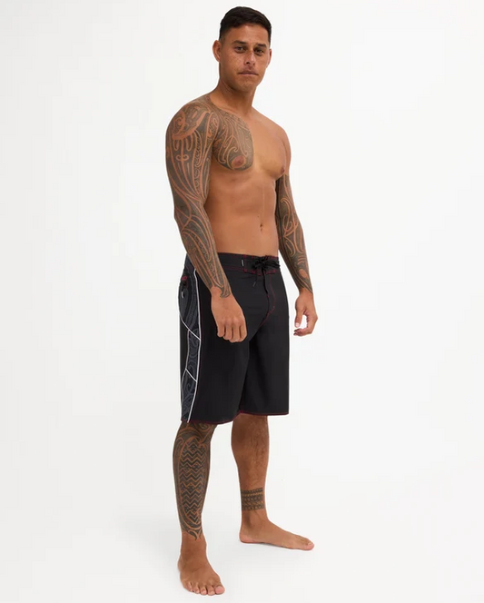 Quiksilver Tai Kehu Takarangi 21" Maori Boardshorts in black, white and red on Kehu Butler from the side
