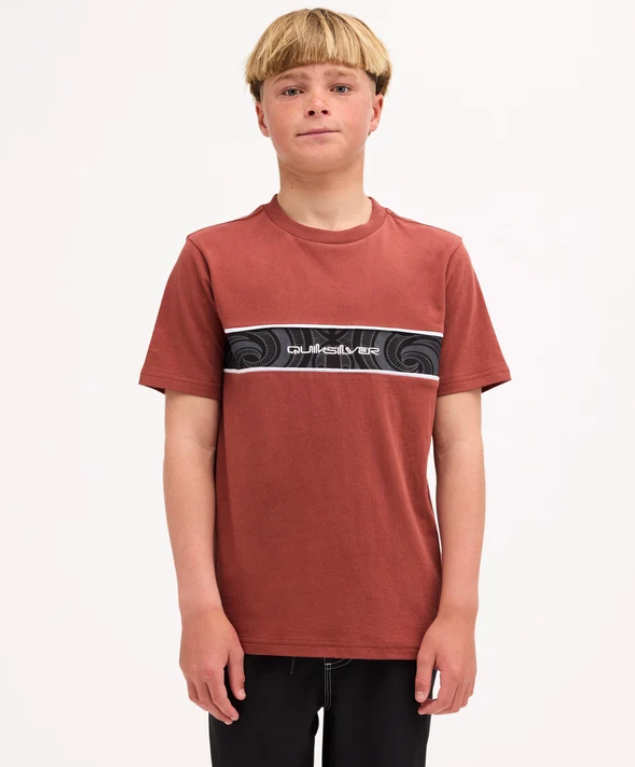 Quiksilver Tai Kehu Takarangi Panel Boys T-Shirt in henna colourway on youth model in Maori boardshorts from the front close up