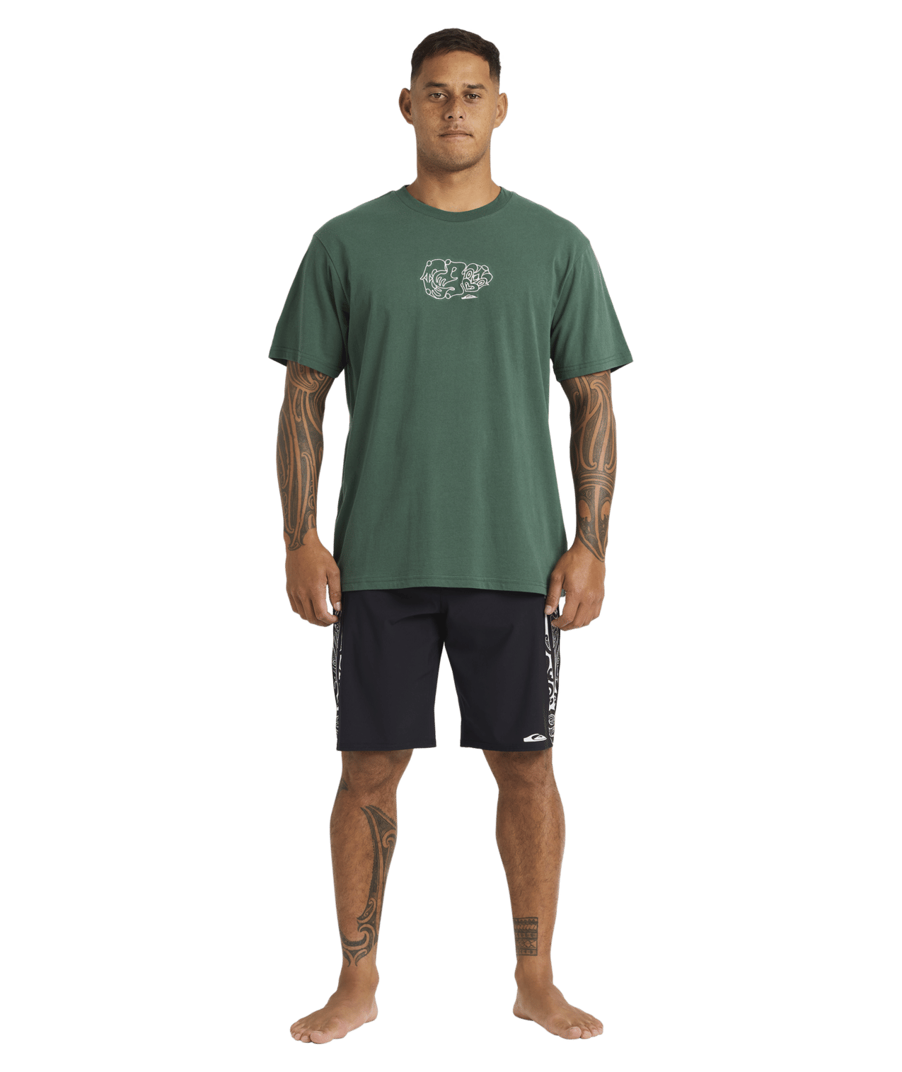 Quiksilver Tai Kehu Tiki T-Shirt in jungle green from front on Kehu Butler in Maori boardshorts full length