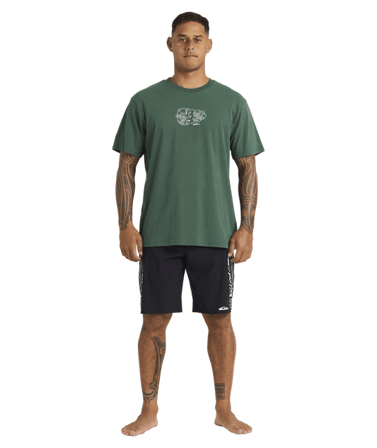 Quiksilver Tai Kehu Tiki T-Shirt in jungle green from front on Kehu Butler in Maori boardshorts full length