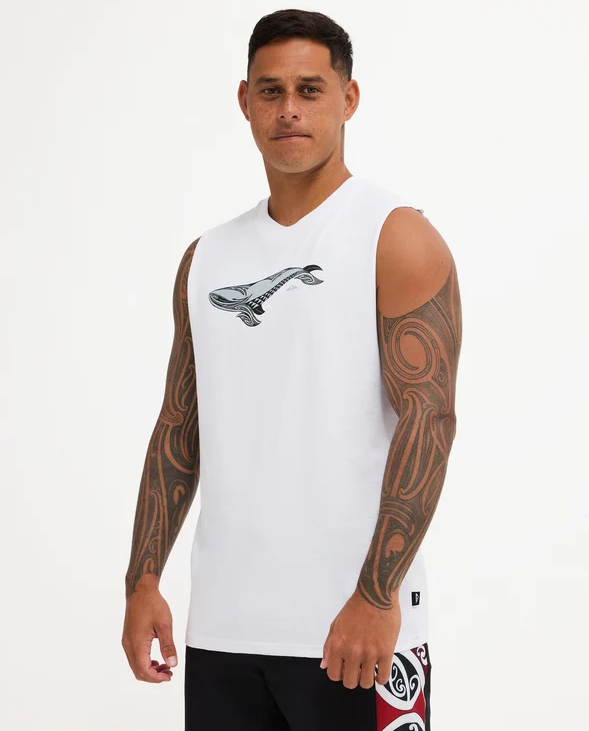 Quiksilver Tai Kehu Tohora Muscle in white with a whale on it on Kehu Butler wearing Quiksilver Maori boardshorts from the side