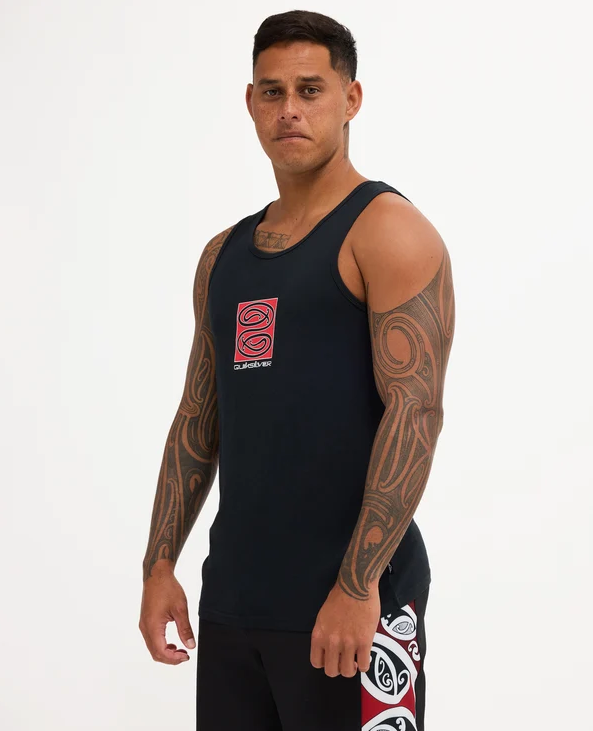 Quiksilver Tai Kehu Tuna Heke Tank in black on Kehu Butler wearing Maori boardshorts from the side