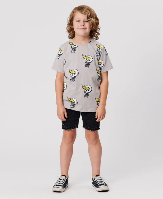 Radicool Kids Skull Repeat Tee in concrete coourway on model from front