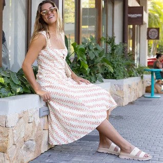 Reef Vista Luxe Thea Sandals on a woman's feet by a cafe