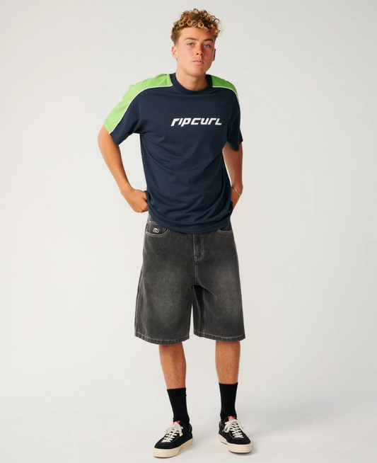 Rip Curl Archine 23" Dirty Denim Shorts in washed grey on model in navy and green rip curl tee from the front