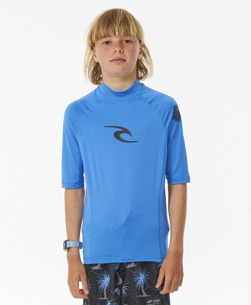 Blond boy with mullet wearing a Rip Curl Brand Wave UPF S/S Boy's Rash Tee in blue gum