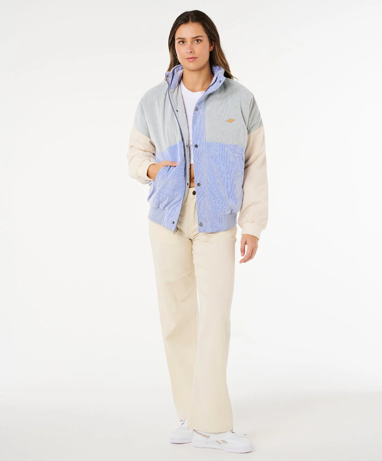 Rip Curl Cala Vadella Women's Corduroy Jacket in sage colourway with sky blue and off white panels on model in natural coloured pants from front