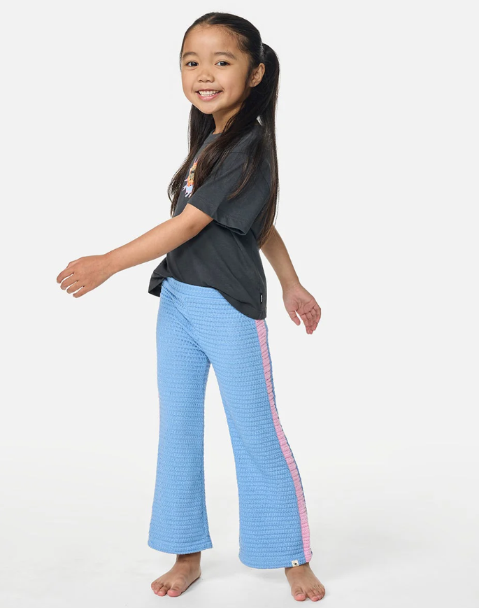 Rip Curl Girls Surf Magic Pants in blue with pink stripe on model in dark tee from front