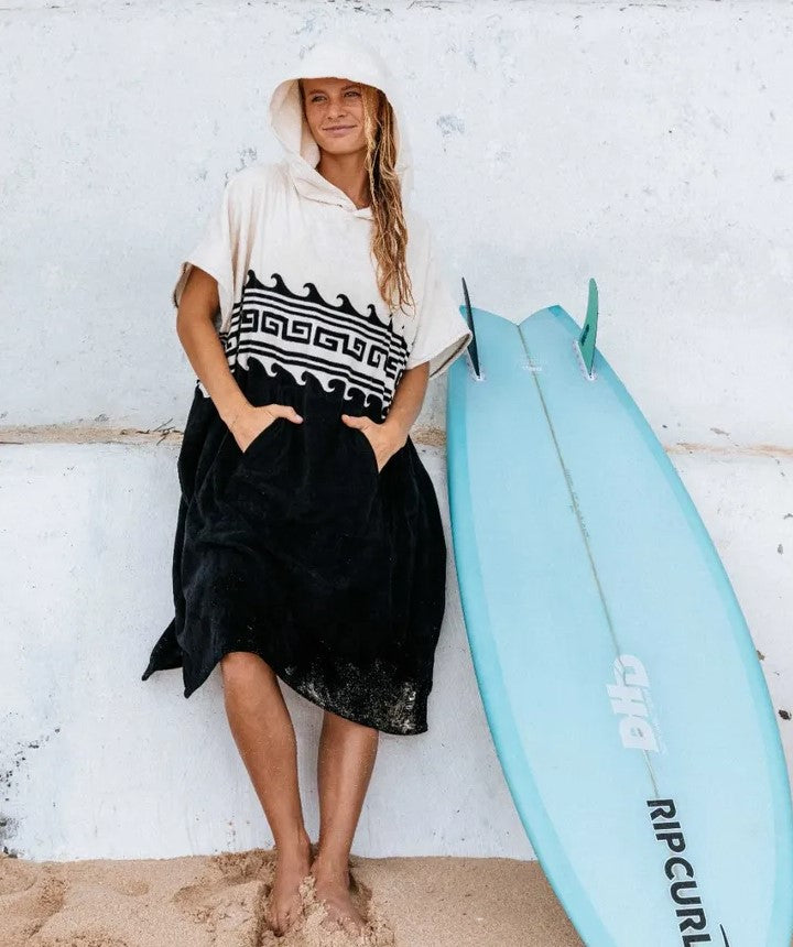 Rip Curl Mixed Hooded Towel in black with oatmeal colourway on model by her surfboard