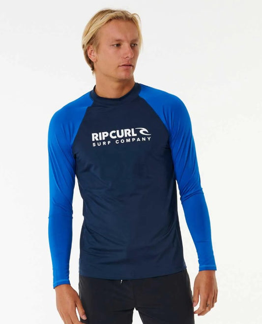 Blond model wearing Rip Curl Shock Men's L/S Rash Tee in dark navy and royal blue colours