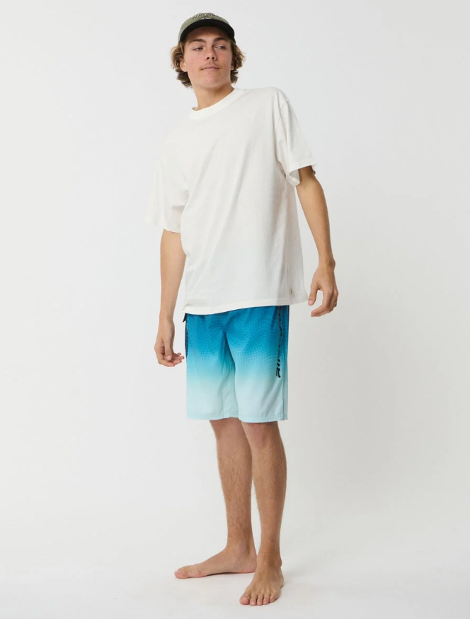 Rip Curl Shockwave 21" Men's Boardshorts in blue fade on model in white tee and khaki cap