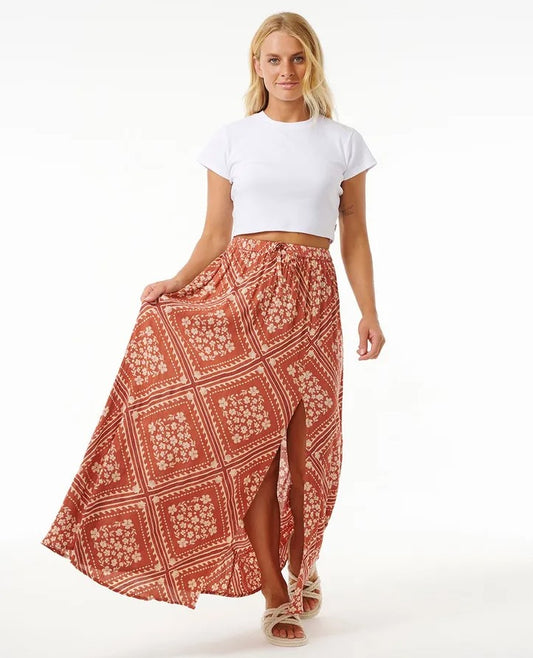 Rip Curl Soleil Maxi Skirt in rust colourway from front on model holding skirt out