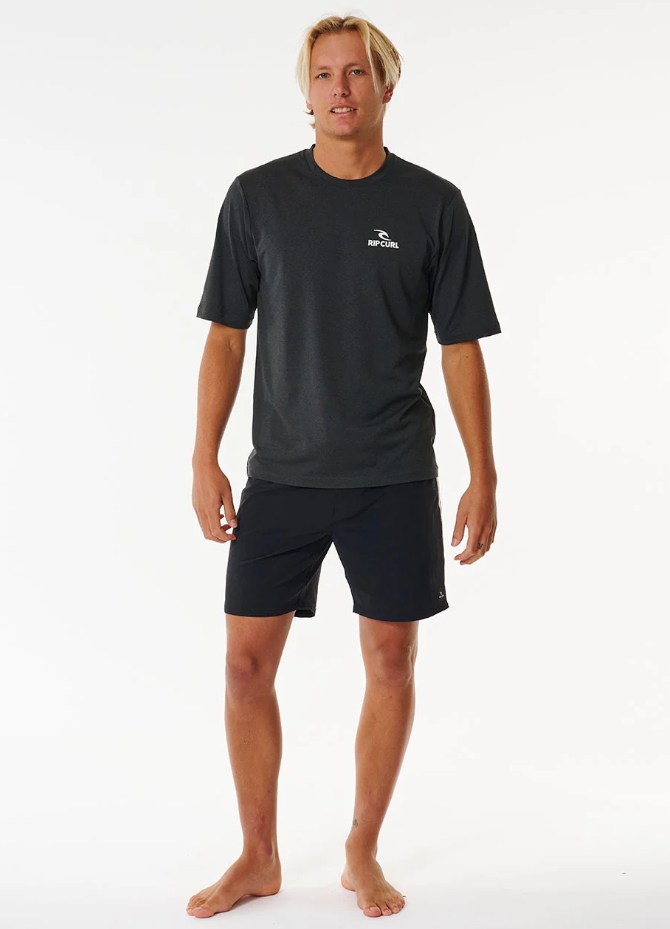 Rip Curl Stack Brand Icon UPF S/S Rash Tee in black marle on model in black boardshorts