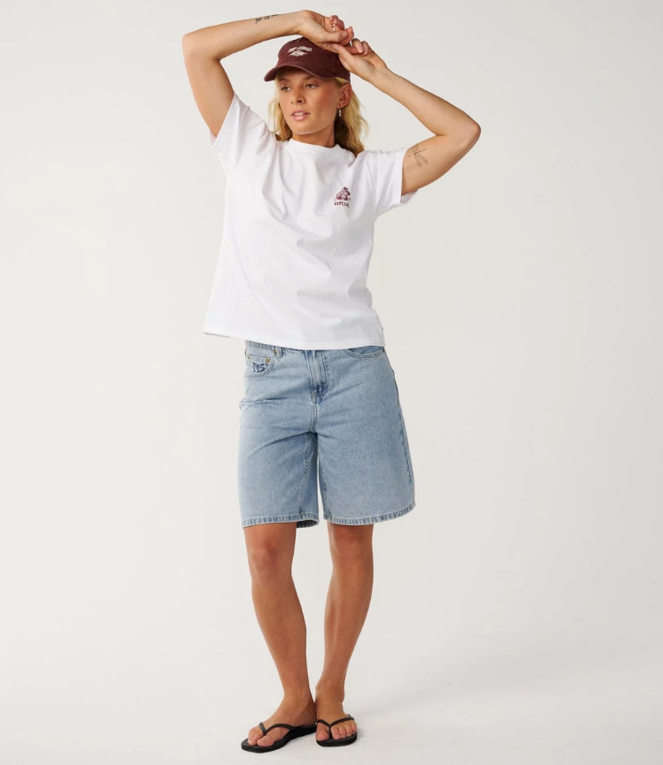 Rip Curl Surf Puff Party Relaxed Tee in white from the front on model in denim shorts and Rip Curl cap