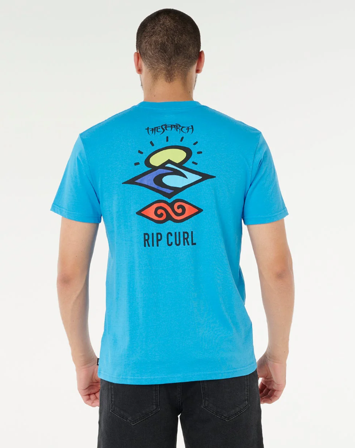 Person wearing a blue Rip Curl t-shirt with a colorful graphic on the back against a white background