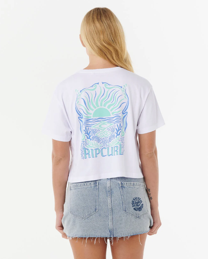 Rip Curl Women's Sunrise Crop Tee in white on model in blue denim skirt from rear